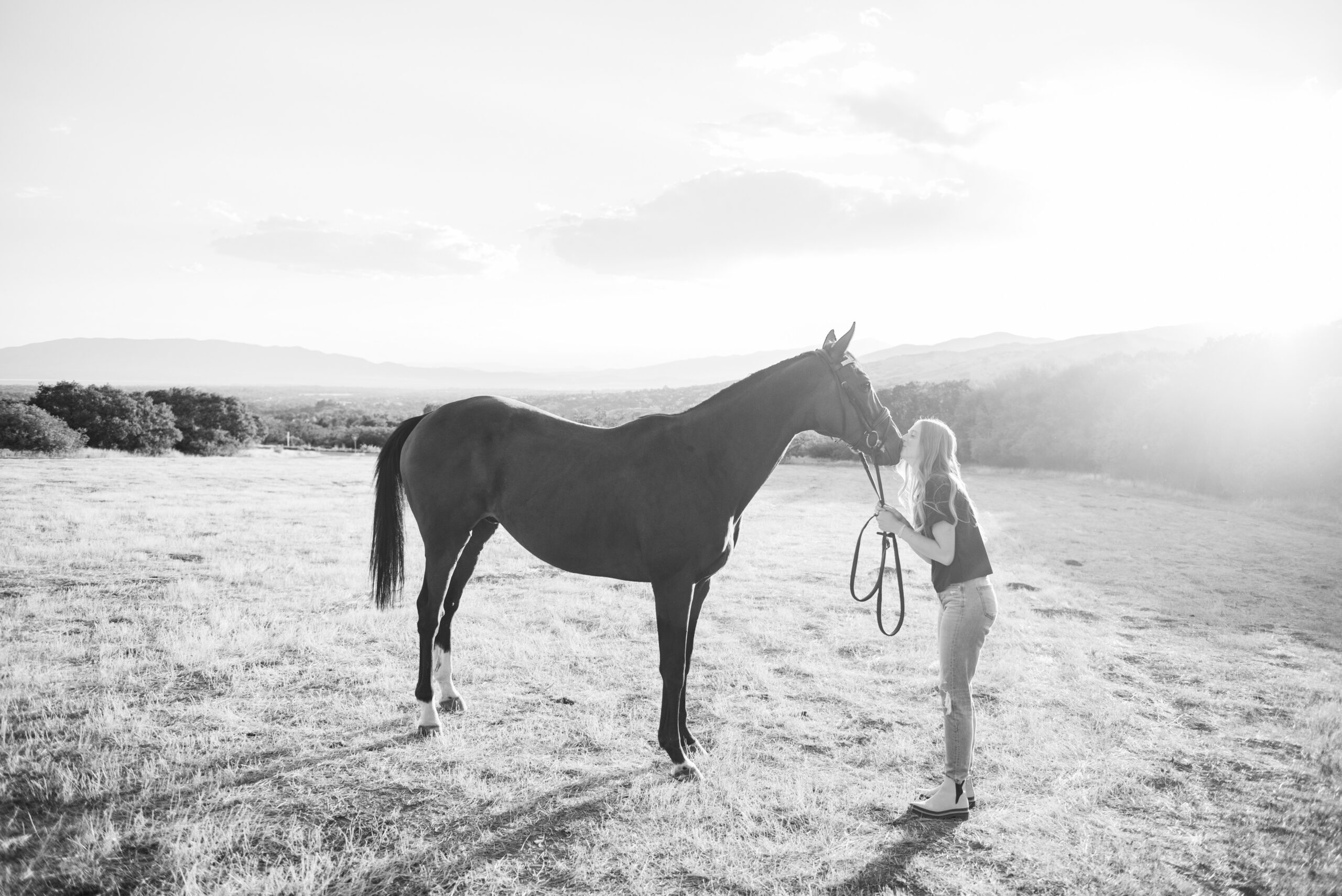 black and white Senior Portraits at Alpine Rodeo Grounds with horse
