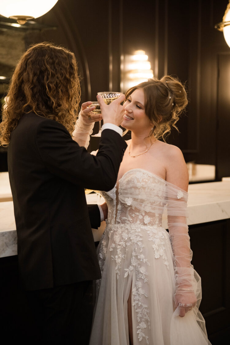 Moody wedding photography with bride and groom cheers