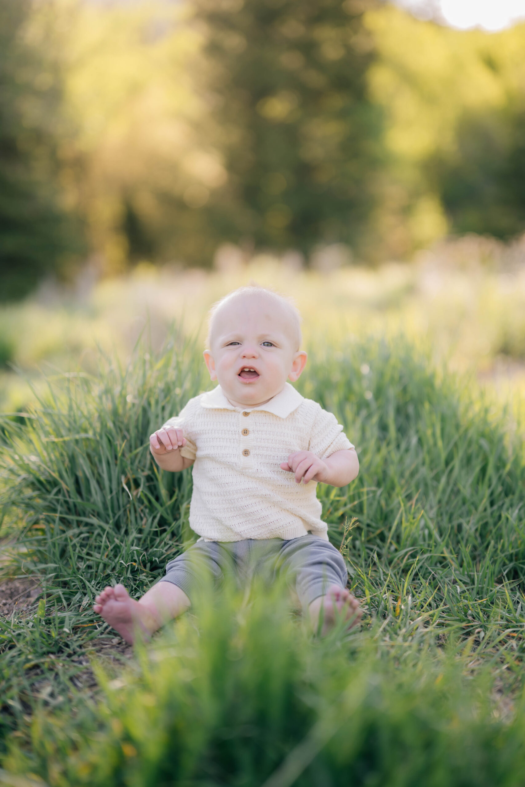 Baby solo photo sitting in grass for a summer family session