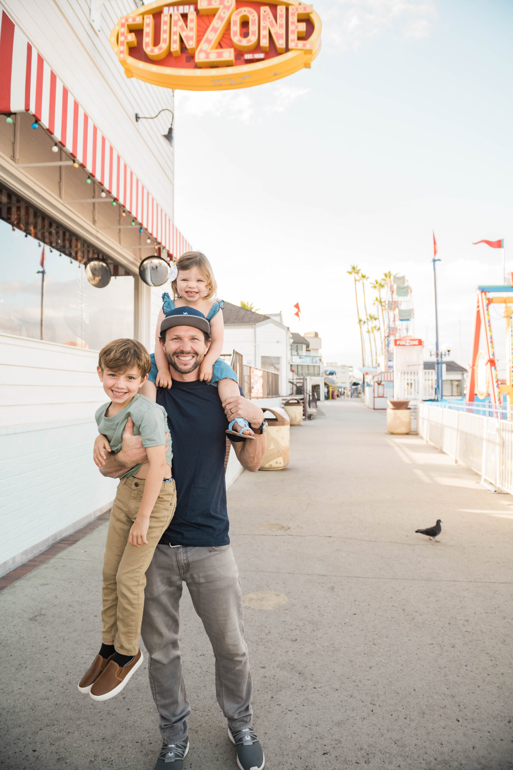 Father and Kids portrait in front of Balboa FunZone sign, summer lifestyle session