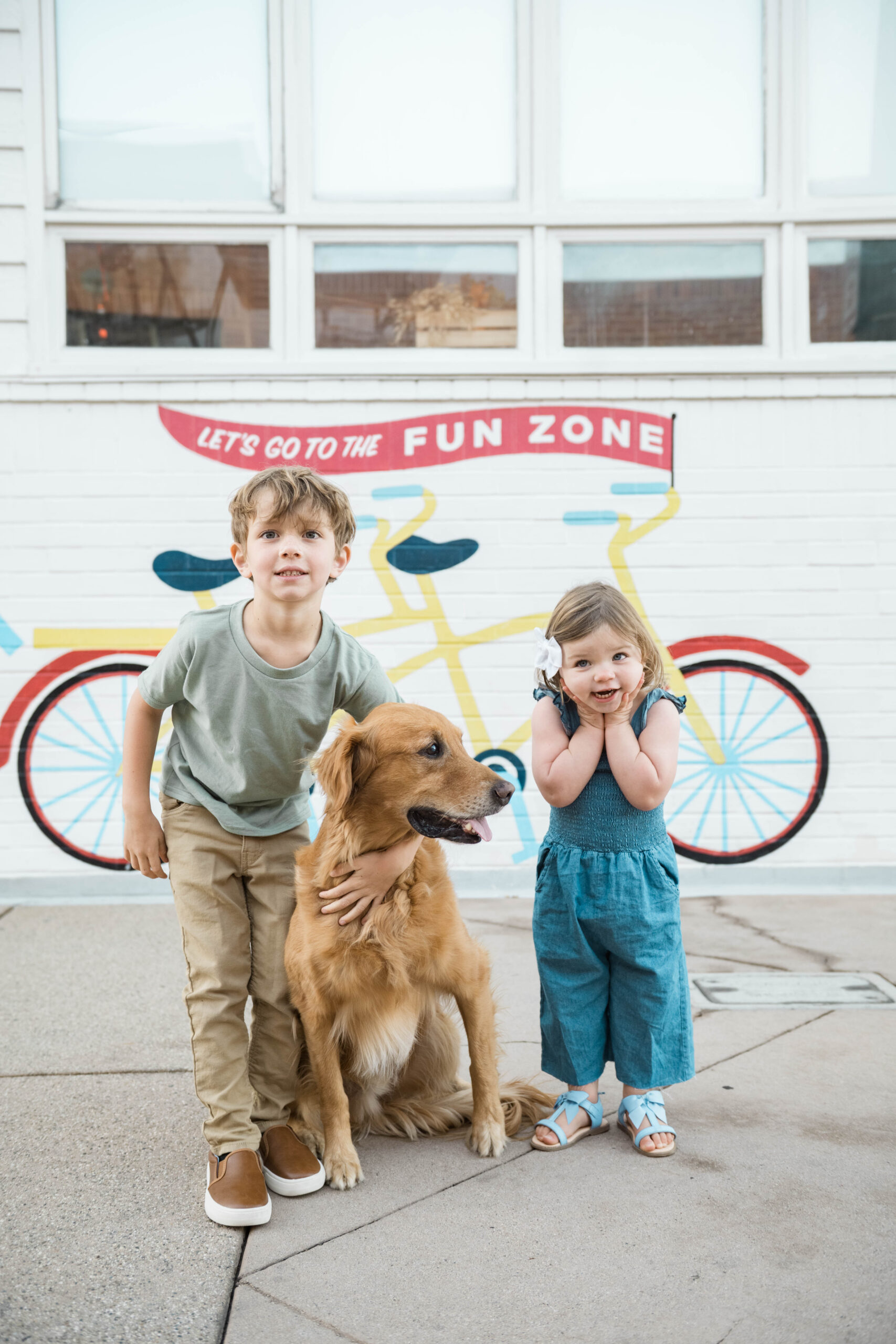 Kids with golden retriever in front of a colorful mural, Balboa Fun Zone in a Southern California family session